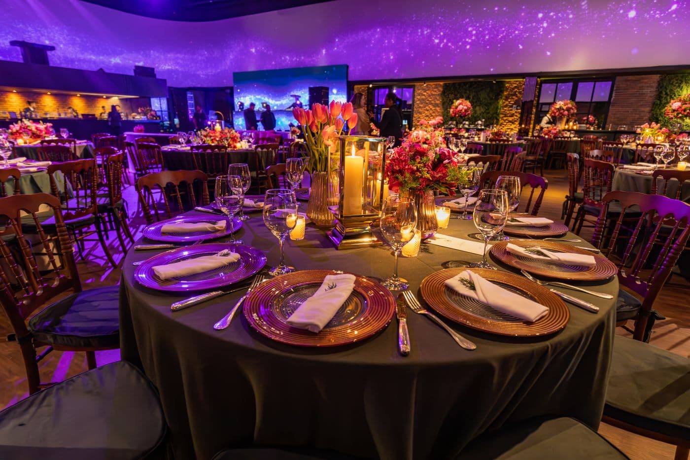 Candlelit banquet hall with purple and gold ambient lighting