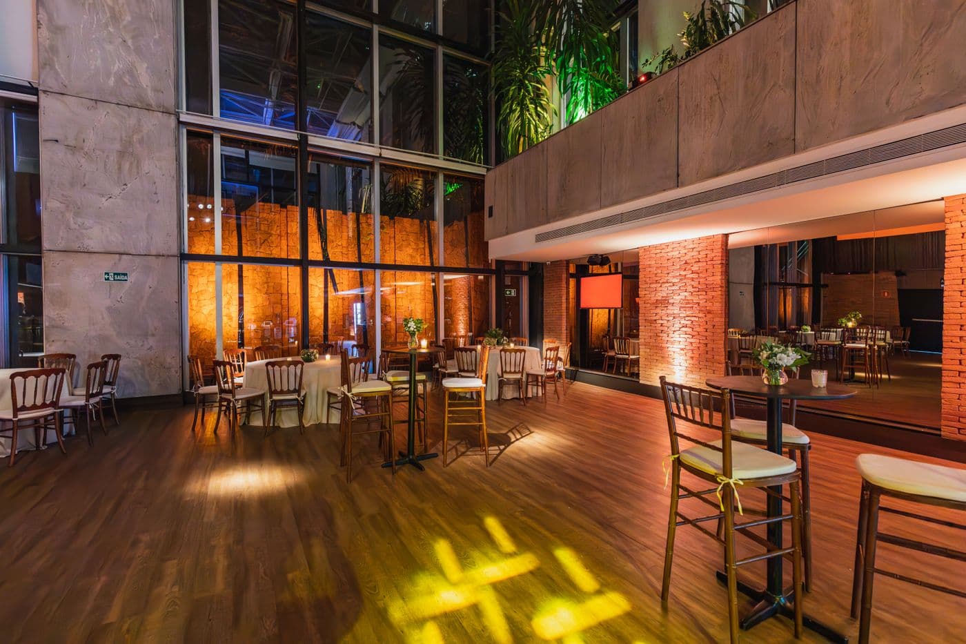 Warm event venue interior with wood floors and brick