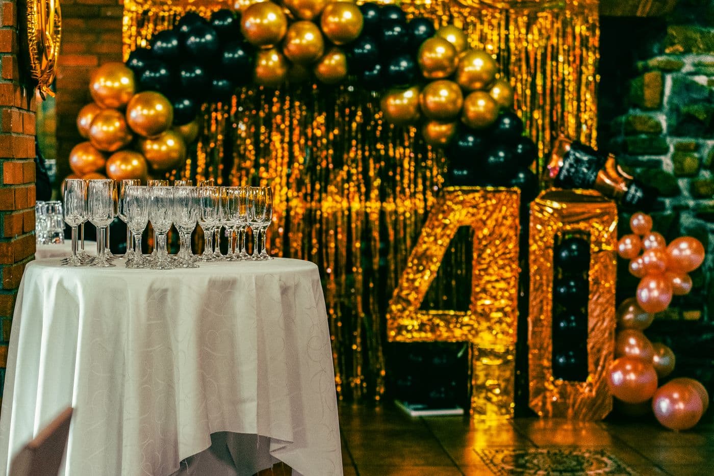 Gold glitter 40th birthday setup with champagne